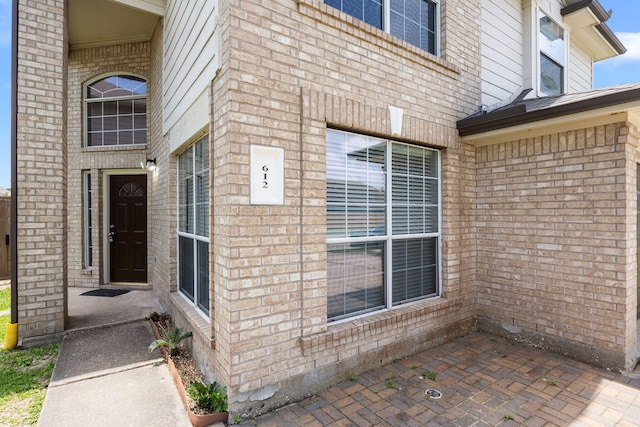 612 Hartman Dr, Baytown, TX 77521 - view of exterior entry featuring brick siding
