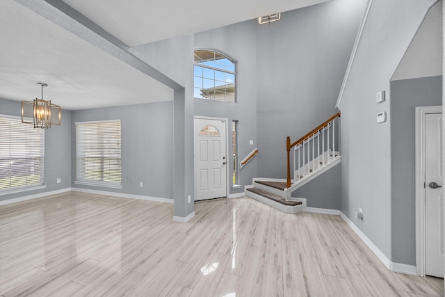 612 Hartman Dr, Baytown, TX 77521 - entrance foyer featuring baseboards, a chandelier, stairway, and light wood finished floors
