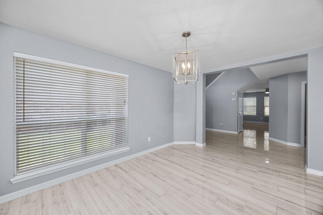 612 Hartman Dr, Baytown, TX 77521 - unfurnished room featuring a chandelier, baseboards, and wood finished floors