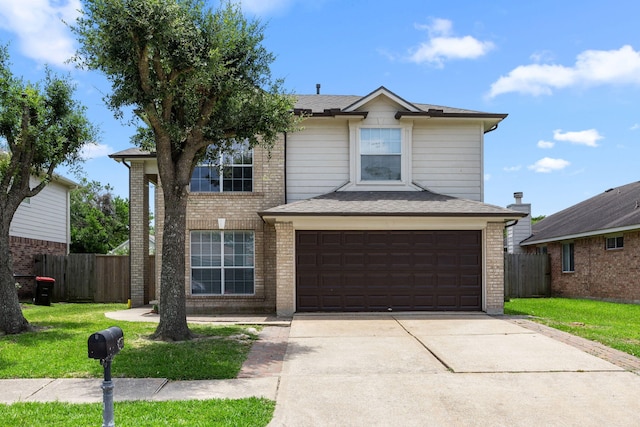 612 Hartman Dr, Baytown, TX 77521 - traditional-style house featuring an attached garage, driveway, and brick siding