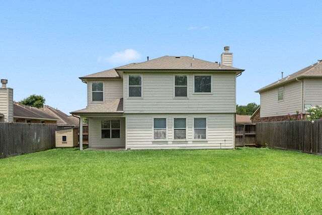 612 Hartman Dr, Baytown, TX 77521 - back of house featuring a chimney and roof with shingles