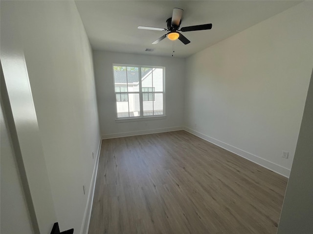 6412 Highland Pine Ln, Houston, TX 77091 - spare room featuring wood finished floors, baseboards, and a ceiling fan