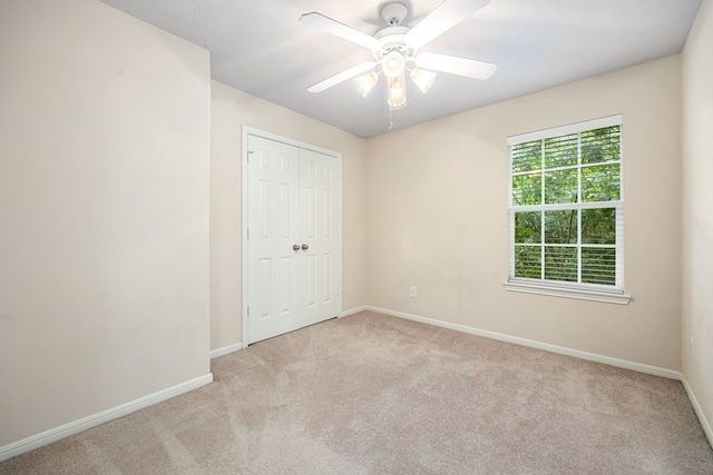 6352 Austinville Dr, Katy, TX 77449 - unfurnished bedroom featuring carpet floors, baseboards, a closet, and a ceiling fan