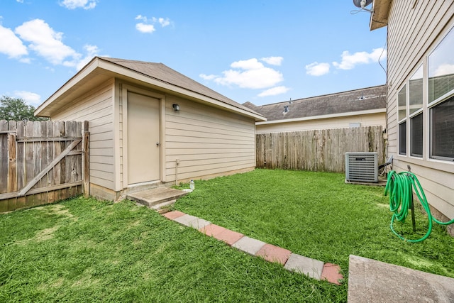 6352 Austinville Dr, Katy, TX 77449 - view of yard featuring central AC and an outdoor structure