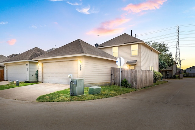6352 Austinville Dr, Katy, TX 77449 - view of side of home featuring a garage, driveway, and a shingled roof