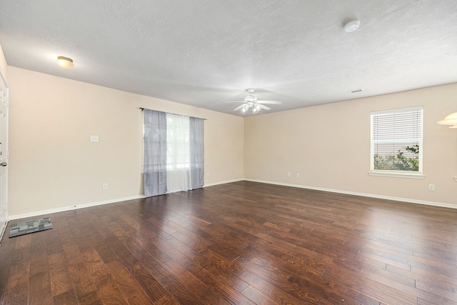 6352 Austinville Dr, Katy, TX 77449 - empty room featuring plenty of natural light, hardwood / wood-style floors, ceiling fan, a textured ceiling, and baseboards