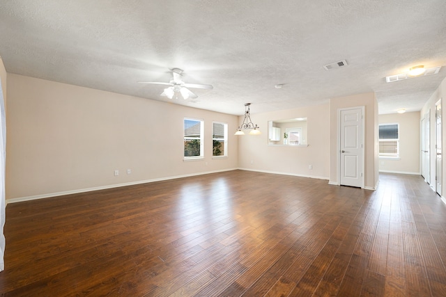 6352 Austinville Dr, Katy, TX 77449 - unfurnished living room with ceiling fan, a textured ceiling, baseboards, and dark wood-type flooring