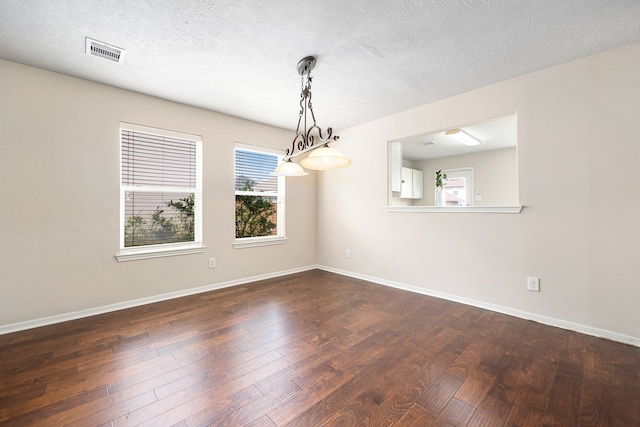 6352 Austinville Dr, Katy, TX 77449 - spare room featuring dark wood finished floors, baseboards, and a textured ceiling