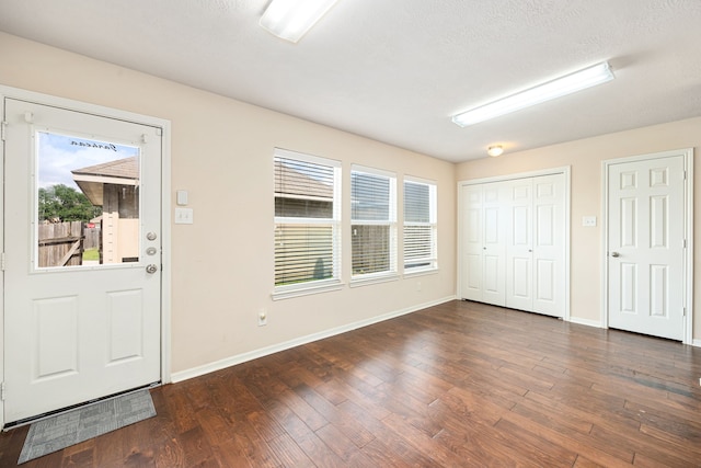 6352 Austinville Dr, Katy, TX 77449 - entryway with plenty of natural light, dark wood-style flooring, and baseboards