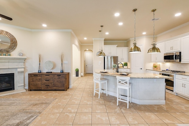 2800 Spencer Ct, Pearland, TX 77089 - kitchen featuring appliances with stainless steel finishes, arched walkways, crown molding, recessed lighting, and decorative backsplash