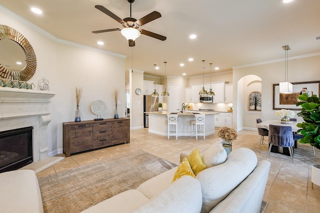 2800 Spencer Ct, Pearland, TX 77089 - living room featuring arched walkways, light tile patterned flooring, ceiling fan, recessed lighting, and a fireplace