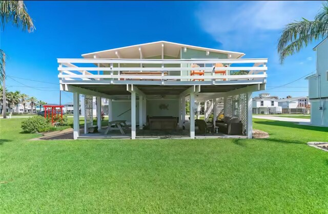 22201 Matagorda Dr, Galveston, TX 77554 - rear view of property featuring a wooden deck, a yard, and a patio area