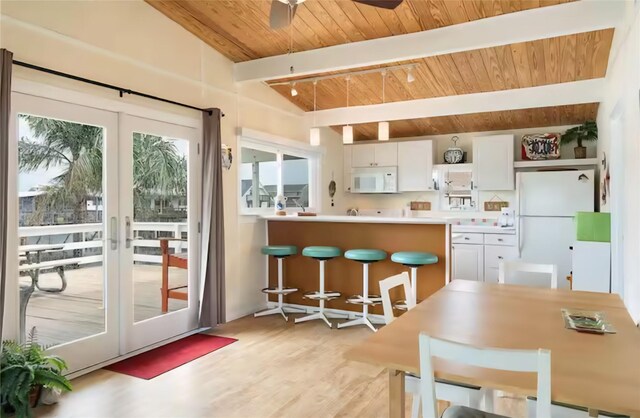 22201 Matagorda Dr, Galveston, TX 77554 - kitchen with white appliances, wood ceiling, white cabinetry, light wood-style flooring, and pendant lighting