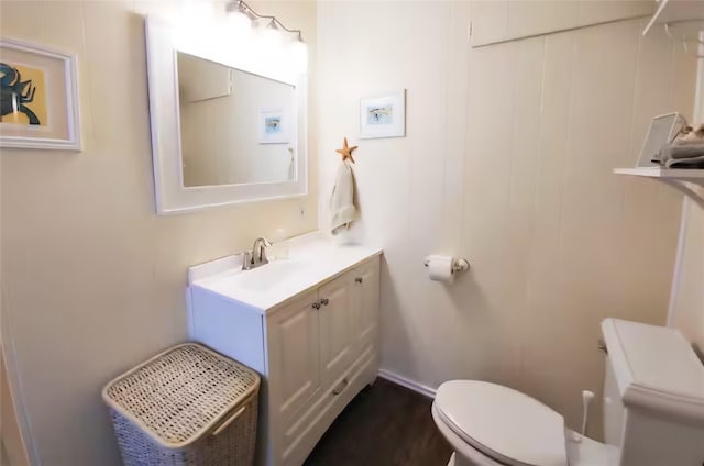 22201 Matagorda Dr, Galveston, TX 77554 - bathroom featuring toilet, vanity, and wood finished floors