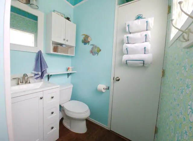 22201 Matagorda Dr, Galveston, TX 77554 - bathroom with vanity, toilet, and wood finished floors