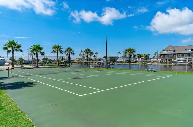 22201 Matagorda Dr, Galveston, TX 77554 - view of tennis court with community basketball court and a water view