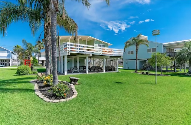 22201 Matagorda Dr, Galveston, TX 77554 - rear view of property with a lawn, a patio area, and a deck