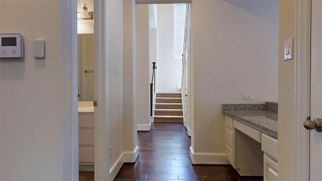 10255 S Goshawk Trl, Conroe, TX 77385 - corridor featuring dark wood-type flooring, baseboards, a desk, and stairs