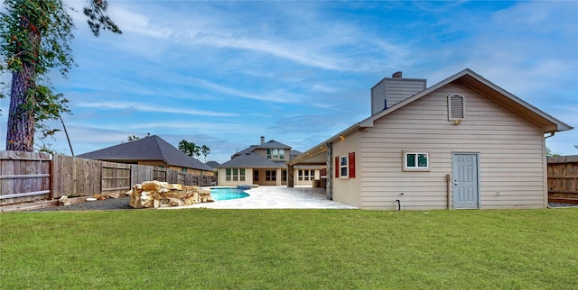 10255 S Goshawk Trl, Conroe, TX 77385 - back of house with a patio area and a chimney