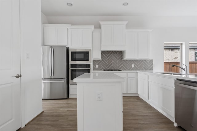 18415 Circle Bar Ranch Ct, Cypress, TX 77433 - kitchen featuring stainless steel appliances, decorative backsplash, light countertops, white cabinetry, and a sink