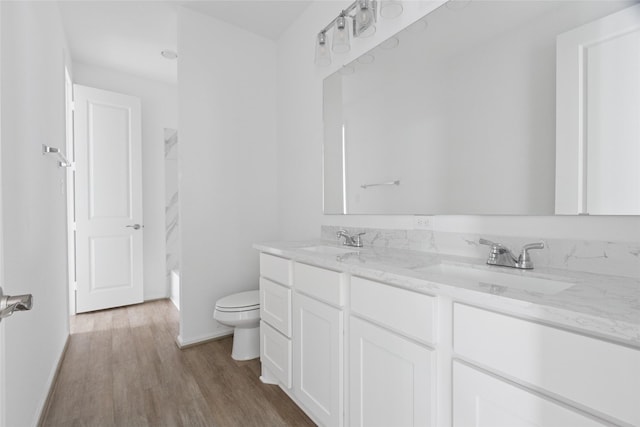 18415 Circle Bar Ranch Ct, Cypress, TX 77433 - bathroom featuring double vanity, toilet, wood finished floors, and baseboards