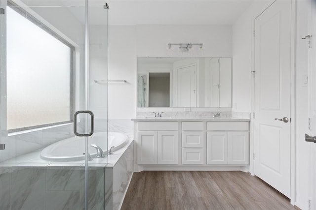 18415 Circle Bar Ranch Ct, Cypress, TX 77433 - full bath featuring double vanity, a garden tub, wood finished floors, and a stall shower