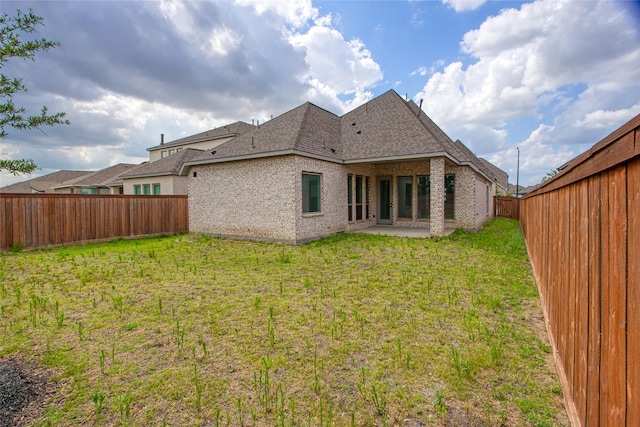 18415 Circle Bar Ranch Ct, Cypress, TX 77433 - rear view of house with roof with shingles, brick siding, and a patio