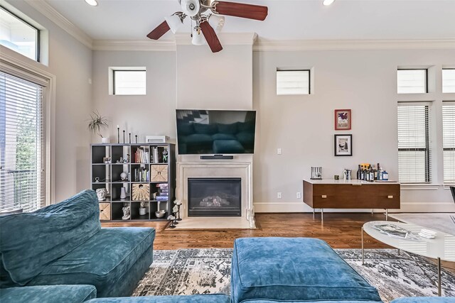 2425 Polk St, Houston, TX 77003 - living area with crown molding, a ceiling fan, wood finished floors, a fireplace with flush hearth, and recessed lighting