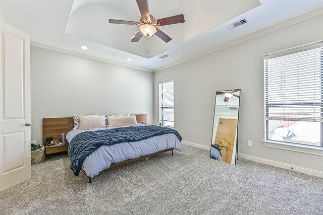 2425 Polk St, Houston, TX 77003 - carpeted bedroom featuring recessed lighting, multiple windows, a raised ceiling, ornamental molding, and baseboards