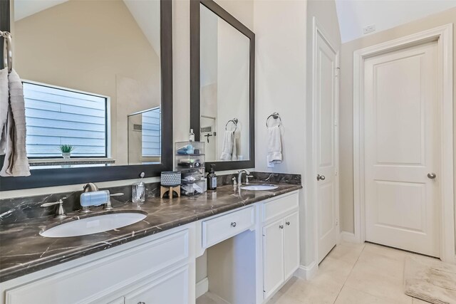 2425 Polk St, Houston, TX 77003 - full bath featuring tile patterned floors, double vanity, and lofted ceiling