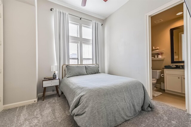 2425 Polk St, Houston, TX 77003 - bedroom featuring light carpet, connected bathroom, baseboards, and ceiling fan