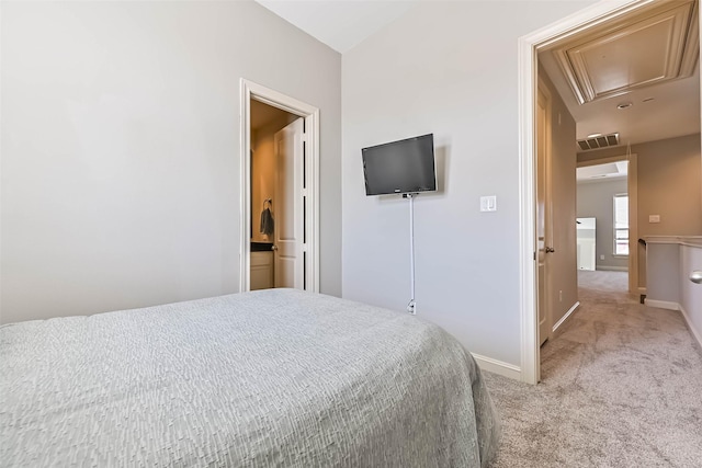 2425 Polk St, Houston, TX 77003 - bedroom featuring attic access, light carpet, and baseboards