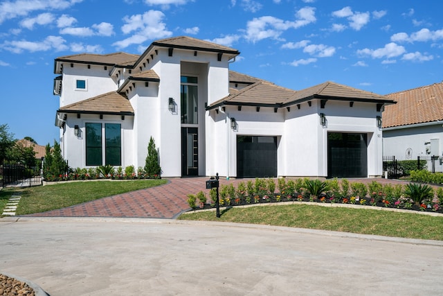 91 Lake Sterling Gate Dr, Spring, TX 77379 - mediterranean / spanish home featuring stucco siding, a garage, driveway, and a tile roof