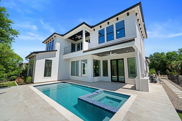 91 Lake Sterling Gate Dr, Spring, TX 77379 - back of property with a ceiling fan, a balcony, a patio area, stucco siding, and a pool with connected hot tub