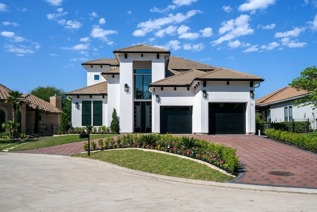 91 Lake Sterling Gate Dr, Spring, TX 77379 - view of front of home featuring an attached garage, stucco siding, and driveway