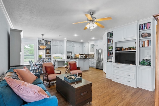 17265 Fm 2154, College Station, TX 77845 - living area featuring a ceiling fan, light wood-type flooring, crown molding, and recessed lighting