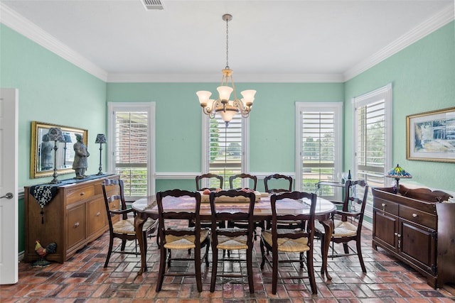 17265 Fm 2154, College Station, TX 77845 - dining space featuring brick floors, a chandelier, and crown molding