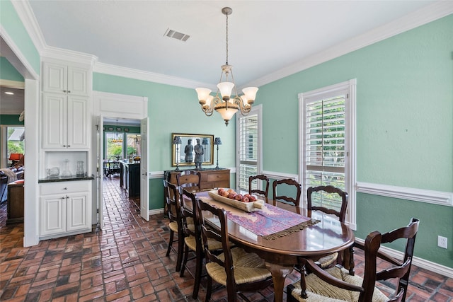 17265 Fm 2154, College Station, TX 77845 - dining area with healthy amount of natural light, a chandelier, ornamental molding, brick floors, and baseboards