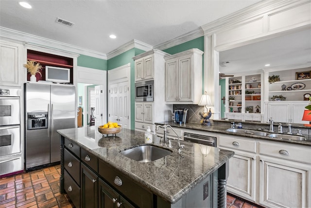 17265 Fm 2154, College Station, TX 77845 - kitchen with appliances with stainless steel finishes, a sink, brick flooring, a warming drawer, and ornamental molding