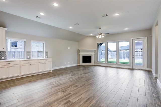 2818 Tanager Trce, Katy, TX 77493 - unfurnished living room with a ceiling fan, wood finished floors, a fireplace, recessed lighting, and lofted ceiling
