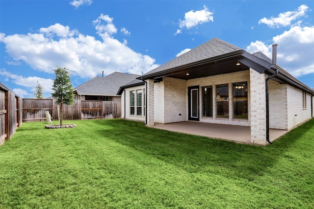 2818 Tanager Trce, Katy, TX 77493 - rear view of house with brick siding, a fenced backyard, a patio, and roof with shingles