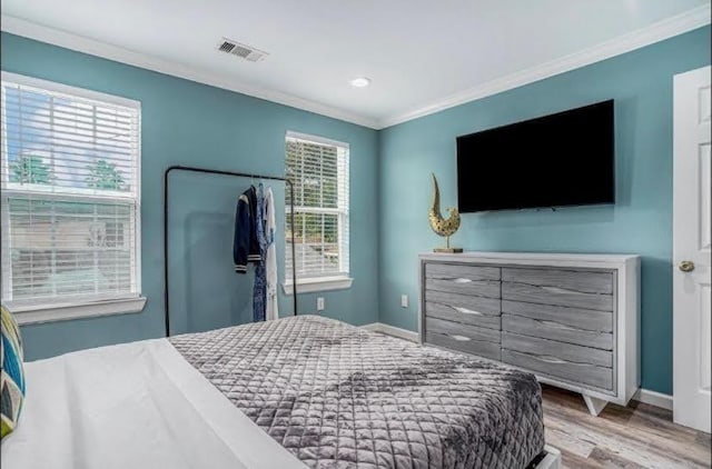 1513 47th St, Galveston, TX 77551 - bedroom featuring crown molding, wood finished floors, baseboards, and recessed lighting