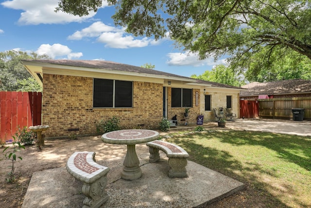 12222 23rd St, Santa Fe, TX 77510 - rear view of property with a patio and brick siding