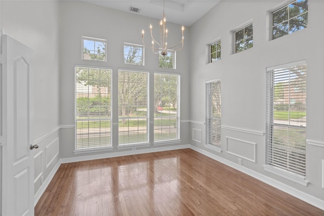 19203 Allview Ln, Houston, TX 77094 - unfurnished dining area with a chandelier, healthy amount of natural light, wood finished floors, and a high ceiling