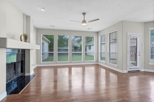 19203 Allview Ln, Houston, TX 77094 - unfurnished living room featuring wood finished floors, ceiling fan, baseboards, a fireplace, and a textured ceiling