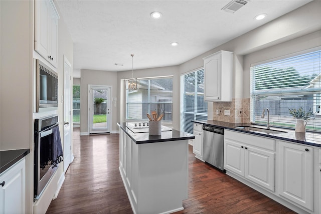 19203 Allview Ln, Houston, TX 77094 - kitchen featuring appliances with stainless steel finishes, a sink, dark countertops, a center island, and recessed lighting