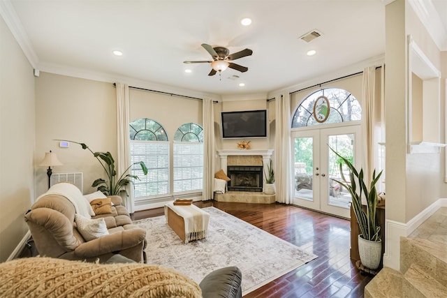 40319 Three Forks Rd, Magnolia, TX 77354 - living area with plenty of natural light, ceiling fan, crown molding, a fireplace with raised hearth, and dark wood-style flooring