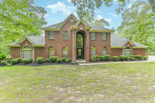 40319 Three Forks Rd, Magnolia, TX 77354 - view of front of home with brick siding, roof with shingles, and a front lawn
