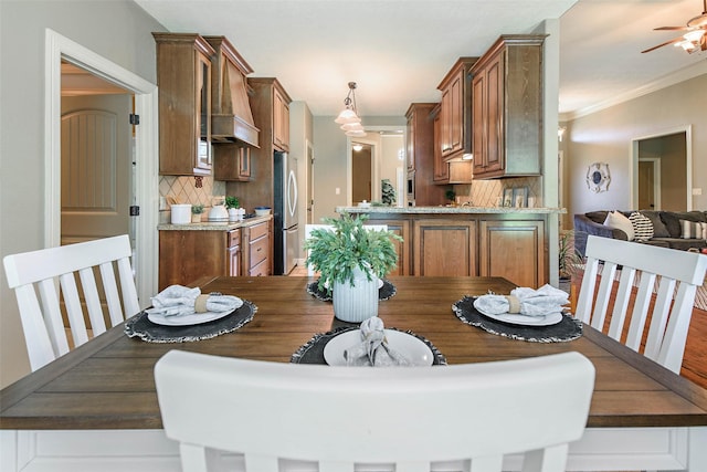2707 Colony Creek Dr, Bryan, TX 77808 - dining space with crown molding, ceiling fan, and wood finished floors