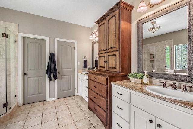2707 Colony Creek Dr, Bryan, TX 77808 - full bath featuring a stall shower, two vanities, and tile patterned flooring